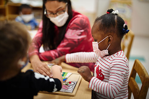 children playing while wearing masks