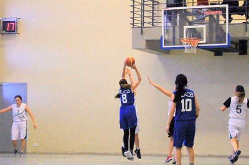 Zarlasht playing with her teammates on the women's basketball team at American University of Central Asia