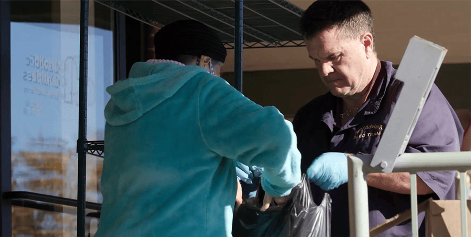 person grabbing food bag