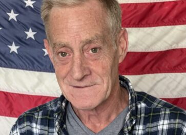 Man in front of American flag