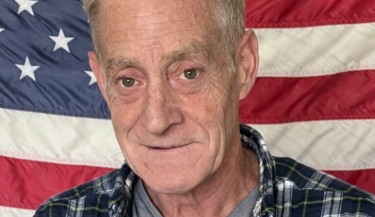 Man in front of American flag
