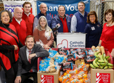 Staff and city officials at a food pantry press conference